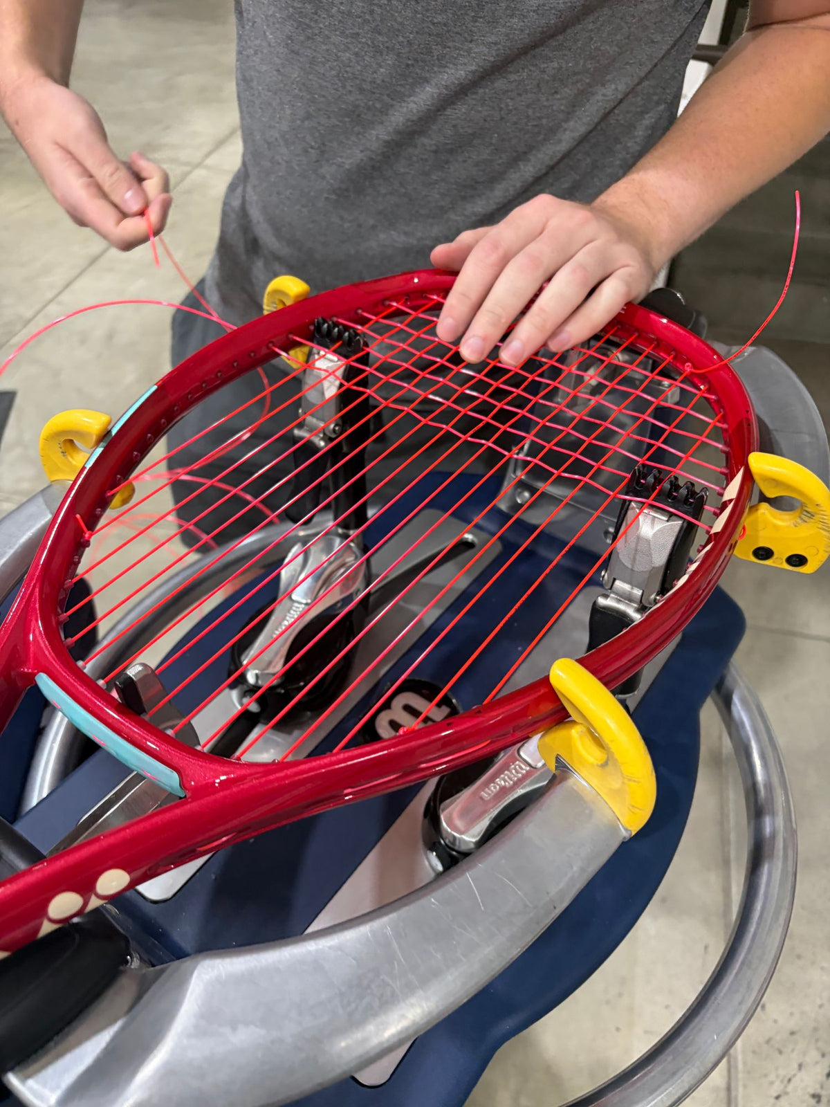 Close-up of a tennis racquet on the stringing machine